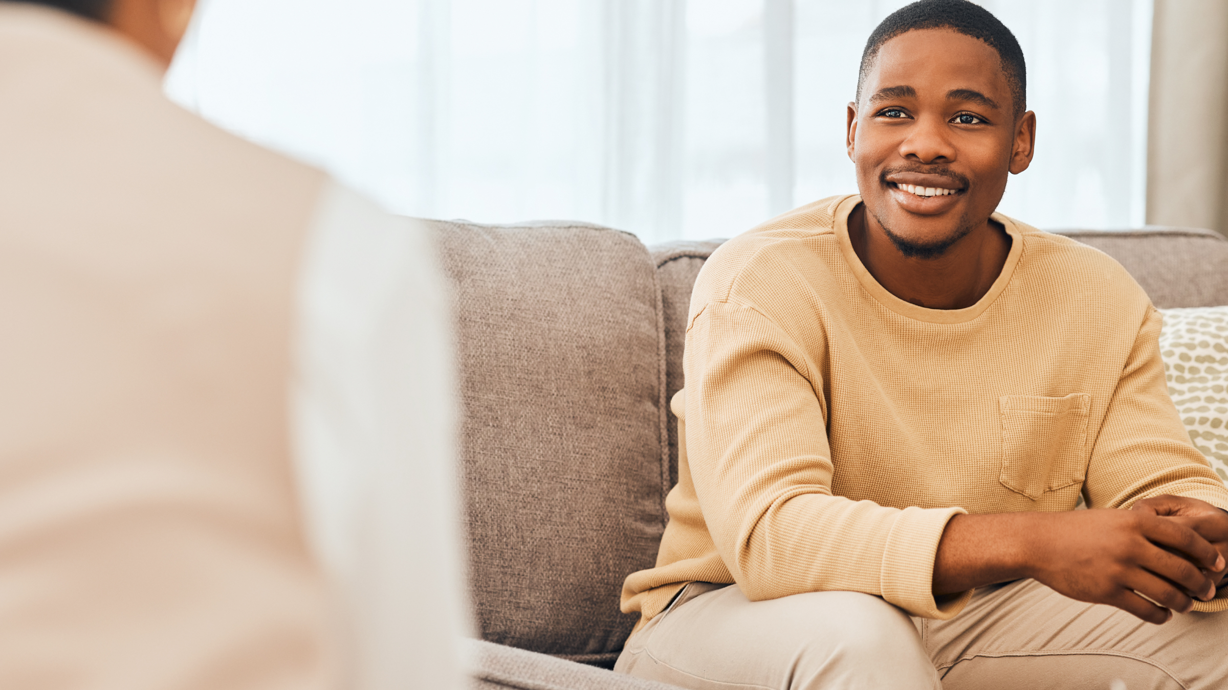 man smiling and holding hands