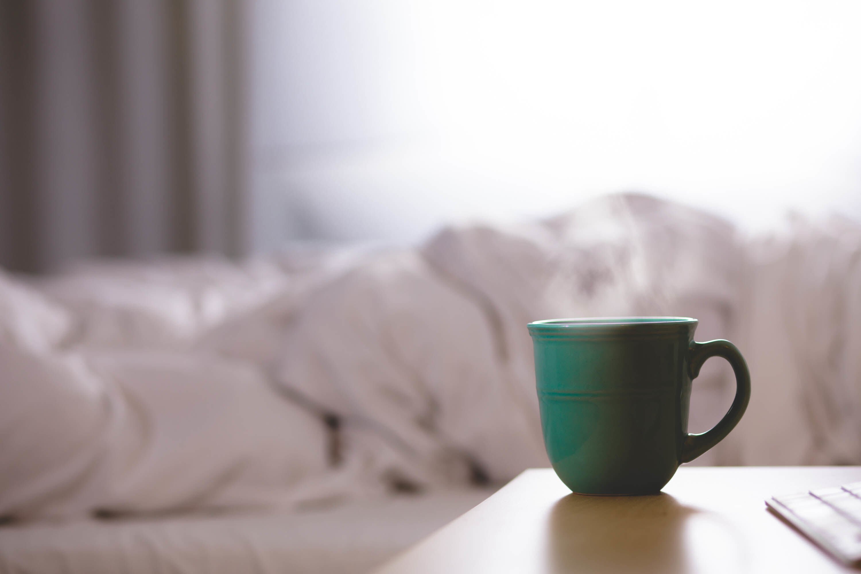 cup of coffee on a bedside table