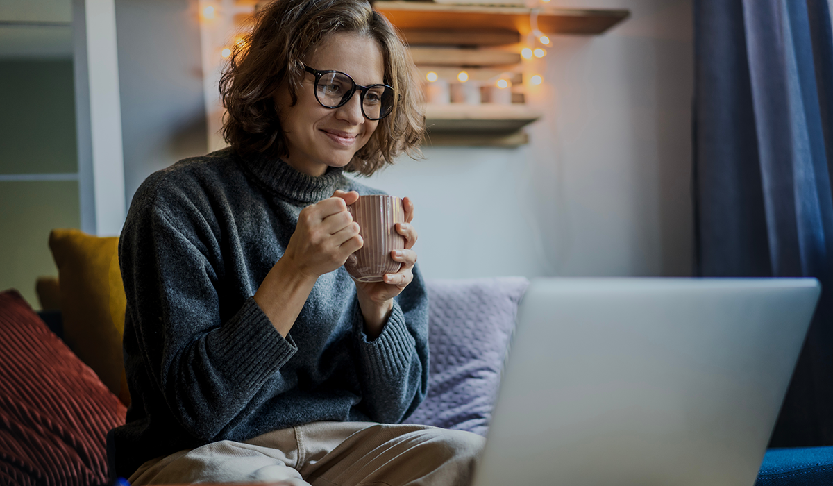 woman at her computer drinking coffee woman at her computer drinking coffee