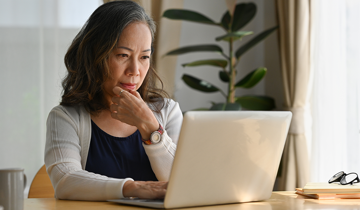 Person sitting in front of computer researching FSA grace period and FSA carryover rules
