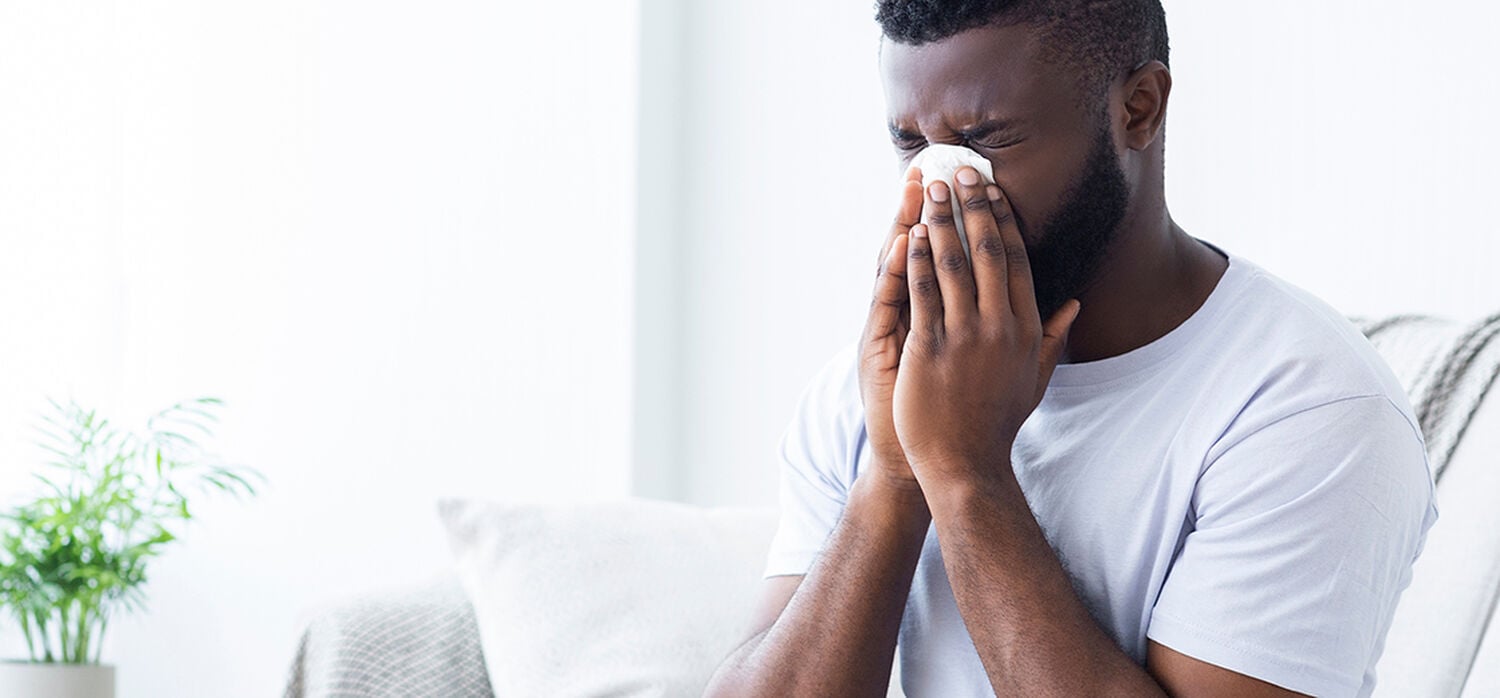 person blowing their nose