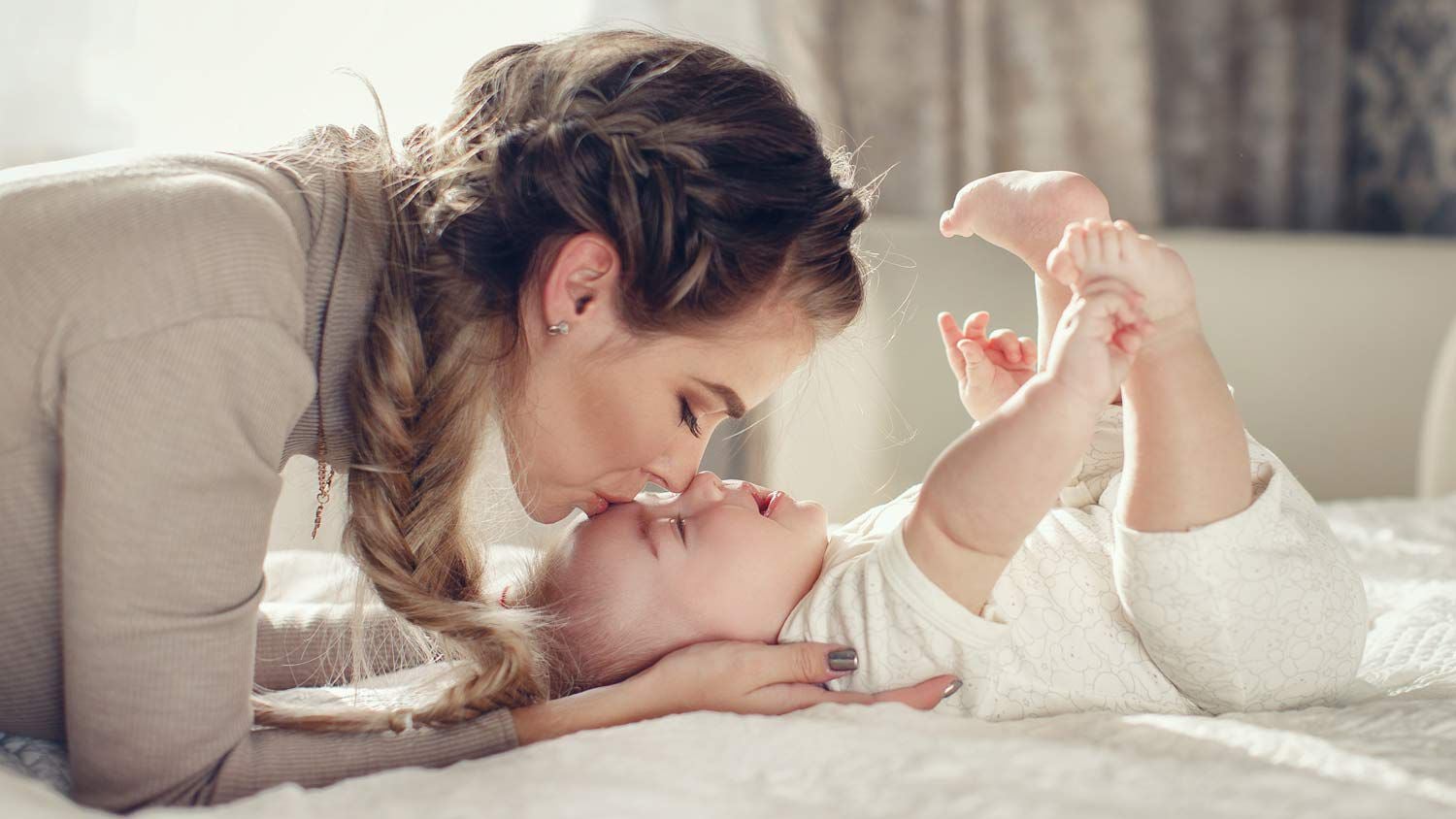 mother kissing her baby