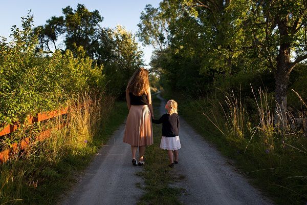 Woman and little girl holding hands Woman and little girl holding hands